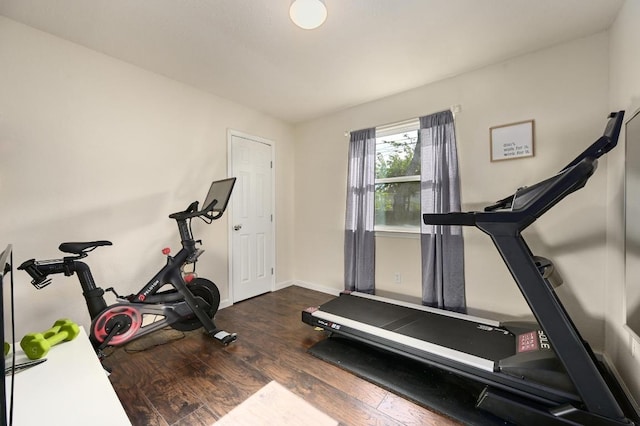 workout area featuring wood finished floors and baseboards