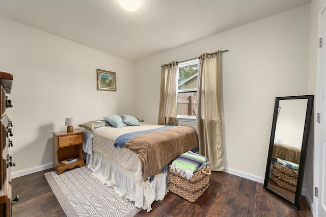 bedroom featuring baseboards and wood finished floors