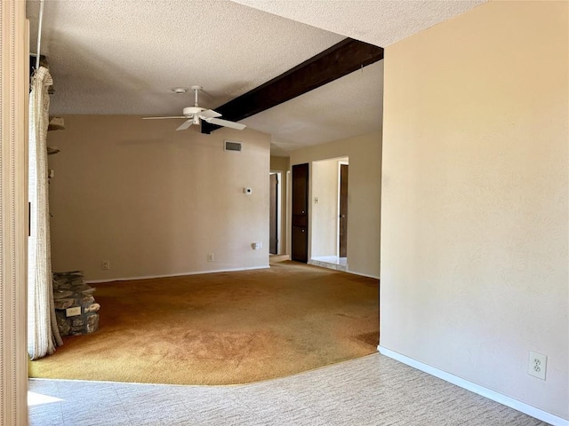 carpeted empty room featuring a ceiling fan, beam ceiling, a textured ceiling, and baseboards