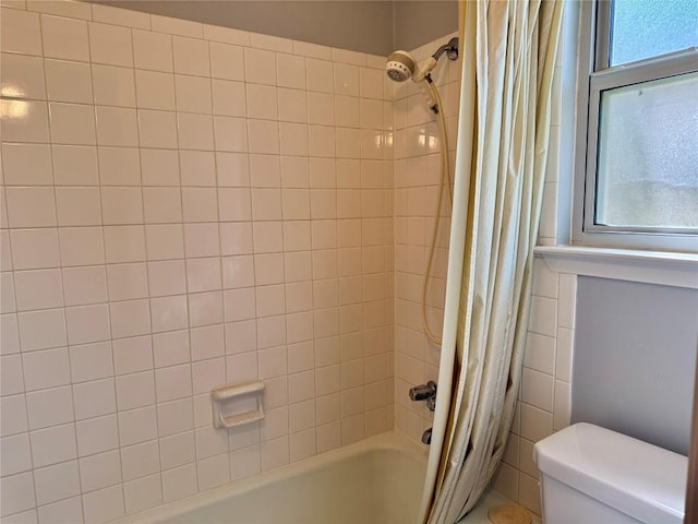 full bath featuring toilet and shower / tub combo with curtain