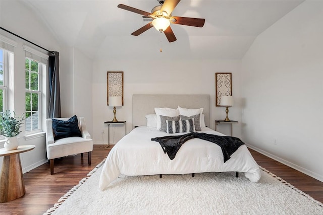 bedroom featuring vaulted ceiling, wood finished floors, baseboards, and ceiling fan