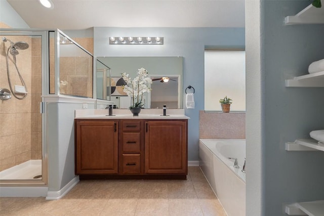 bathroom with a shower stall, tile patterned floors, a bath, and double vanity
