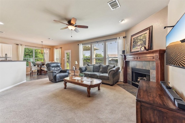 201 Tulip Trail Bnd, Cedar Park, TX 78613 - carpeted living room with a fireplace, ceiling fan, a sink, and baseboards
