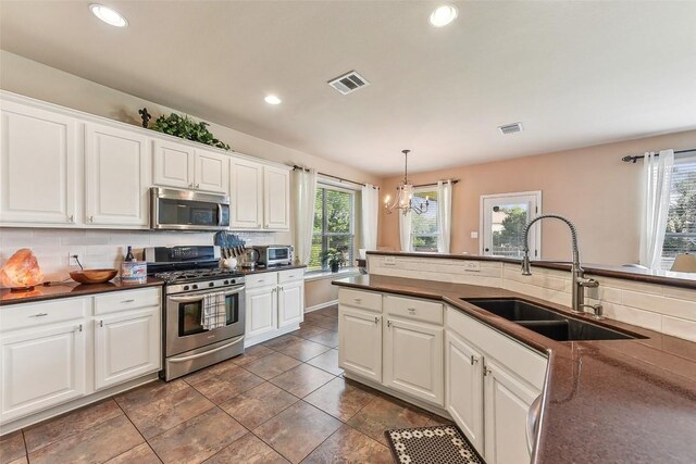201 Tulip Trail Bnd, Cedar Park, TX 78613 - kitchen featuring appliances with stainless steel finishes, dark countertops, tasteful backsplash, white cabinetry, and recessed lighting