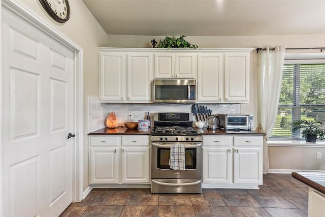 201 Tulip Trail Bnd, Cedar Park, TX 78613 - kitchen featuring appliances with stainless steel finishes, dark countertops, backsplash, and white cabinets
