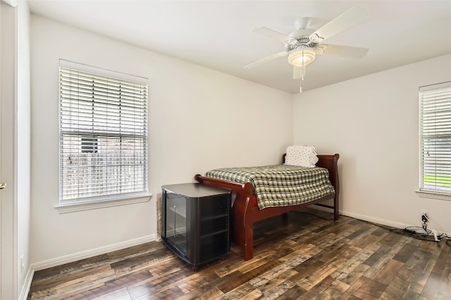 bedroom with wood finished floors, baseboards, and ceiling fan