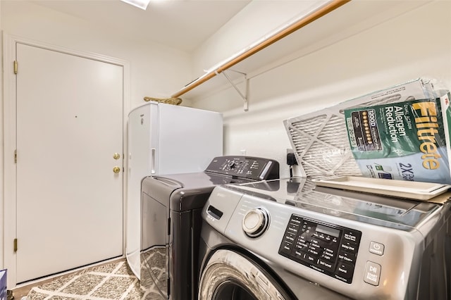 laundry area with independent washer and dryer