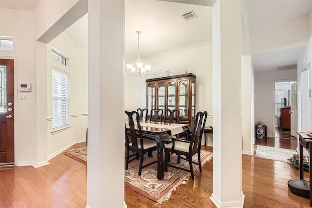 801 Lone Buck Pass, Cedar Park, TX 78613 - dining area featuring wood finished floors, a chandelier, baseboards, and ornamental molding