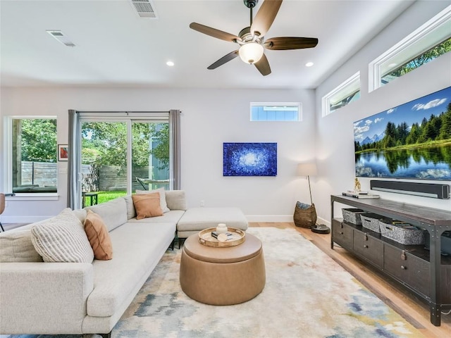 living area featuring baseboards, a ceiling fan, wood finished floors, and recessed lighting