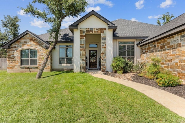 view of front of house featuring stone siding, roof with shingles, and stucco siding