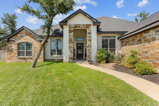 26 Riverstone Pkwy, Belton, TX 76513 - view of front facade featuring stone siding, roof with shingles, and stucco siding