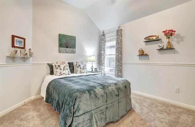 carpeted bedroom featuring lofted ceiling and baseboards