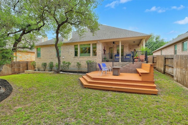 back of property featuring ceiling fan, brick siding, a wooden deck, and roof with shingles