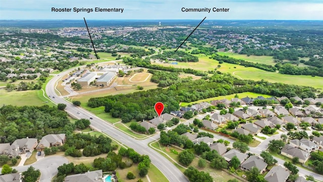 aerial view of residential area with a tree filled landscape
