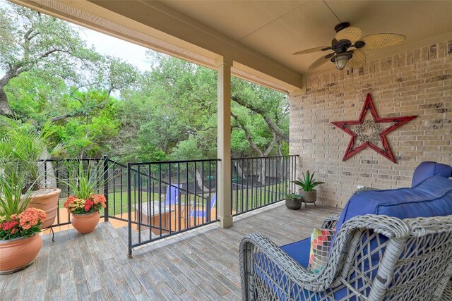 wooden terrace featuring a ceiling fan