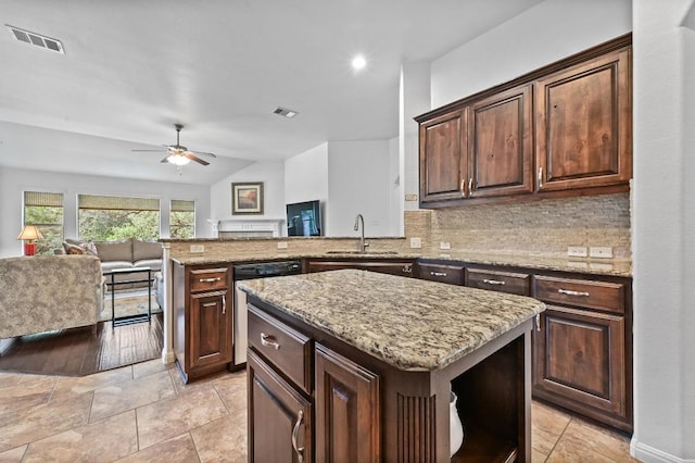 740 Harris Dr, Austin, TX 78737 - kitchen featuring stainless steel dishwasher, ceiling fan, backsplash, open floor plan, and a peninsula