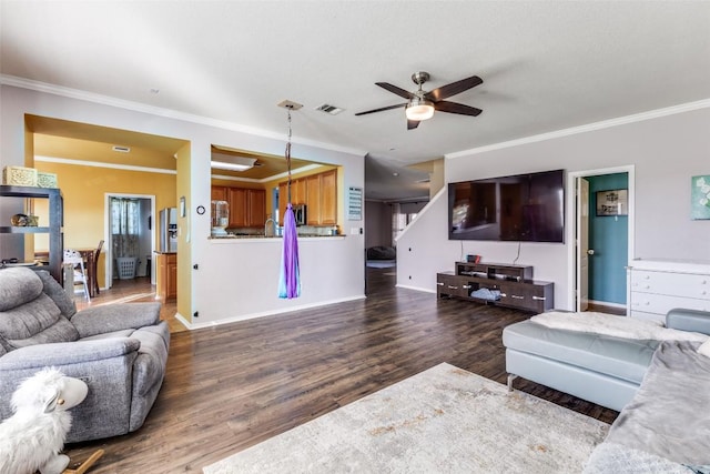 490 Holly Grove St, Kyle, TX 78640 - living room featuring ceiling fan, crown molding, wood finished floors, and baseboards