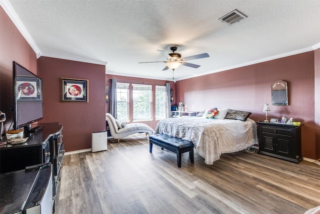 490 Holly Grove St, Kyle, TX 78640 - bedroom featuring ornamental molding, wood finished floors, a textured ceiling, ceiling fan, and baseboards