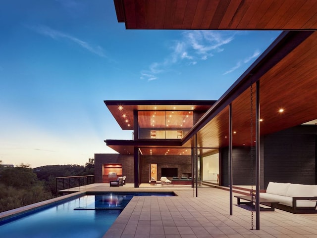 807 Redbud Trl, West Lake Hills, TX 78746 - outdoor pool with an outdoor living space with a fireplace and a patio