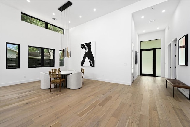3305 Skylark Dr, Austin, TX 78757 - living area with a high ceiling, light wood-style floors, and recessed lighting