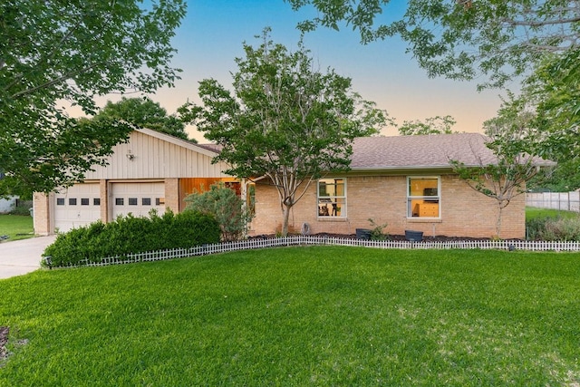 113 Woodland Rd, Georgetown, TX 78628 - ranch-style home with a lawn, brick siding, driveway, and an attached garage