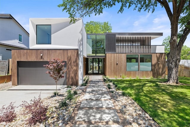2502 Barhill Dr, Austin, TX 78704 - contemporary house featuring concrete driveway, a garage, a front lawn, and a balcony