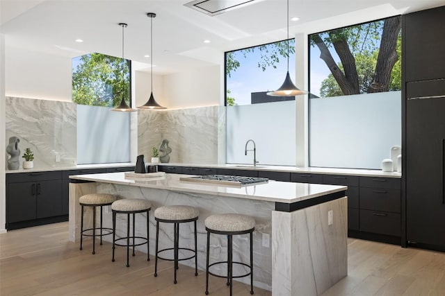 2502 Barhill Dr, Austin, TX 78704 - kitchen featuring stainless steel gas stovetop, modern cabinets, a kitchen island, backsplash, and recessed lighting