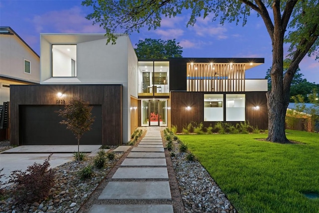 2502 Barhill Dr, Austin, TX 78704 - modern home featuring a front yard, concrete driveway, an attached garage, and a balcony