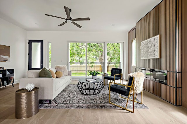 living room featuring a ceiling fan and light wood-style floors