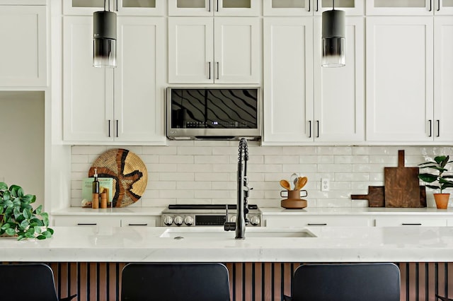 kitchen featuring white cabinets and decorative backsplash