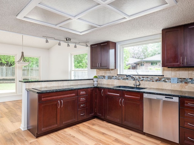 504 Ridgecrest Rd, Georgetown, TX 78628 - kitchen featuring dishwasher, a sink, a peninsula, light wood-style flooring, and a textured ceiling