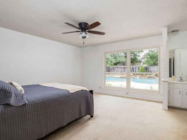 504 Ridgecrest Rd, Georgetown, TX 78628 - bedroom with light carpet, a textured ceiling, and ceiling fan
