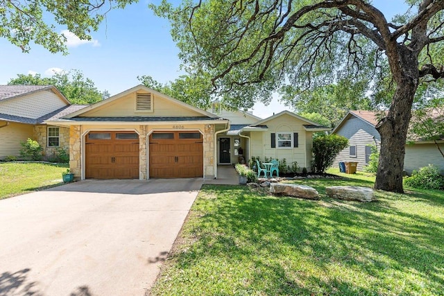 4806 Transit Cir, Austin, TX 78727 - single story home with a garage, stone siding, driveway, and a front yard