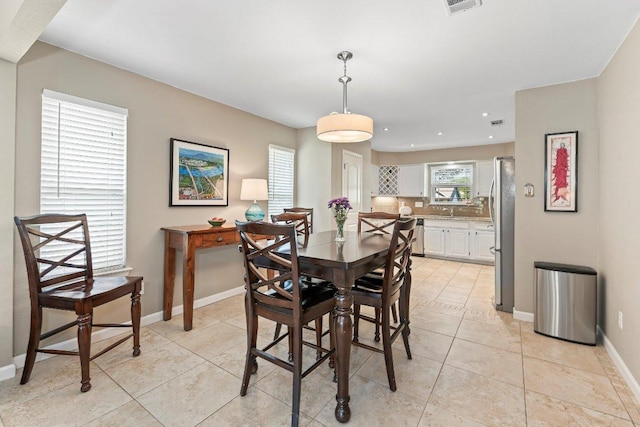 4806 Transit Cir, Austin, TX 78727 - dining area featuring baseboards, light tile patterned floors, and recessed lighting