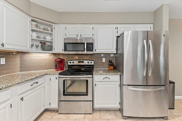 4806 Transit Cir, Austin, TX 78727 - kitchen with stainless steel appliances, white cabinets, backsplash, and light stone countertops