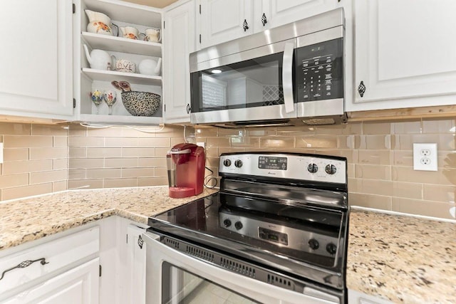 4806 Transit Cir, Austin, TX 78727 - kitchen featuring stainless steel appliances, white cabinetry, open shelves, and backsplash