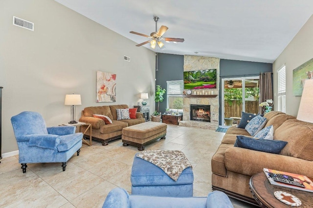 4806 Transit Cir, Austin, TX 78727 - living area with ceiling fan, light tile patterned flooring, a stone fireplace, and high vaulted ceiling