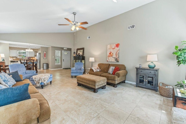 4806 Transit Cir, Austin, TX 78727 - living room with a ceiling fan, baseboards, light tile patterned floors, and high vaulted ceiling
