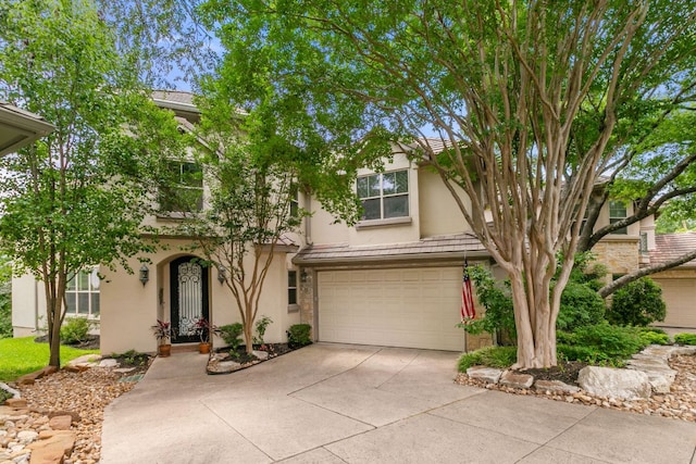 2800 Waymaker Way Unit 26, Austin, TX 78746 - view of property hidden behind natural elements with stucco siding, an attached garage, and concrete driveway