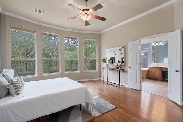 bedroom with light wood finished floors, ornamental molding, ceiling fan, baseboards, and connected bathroom