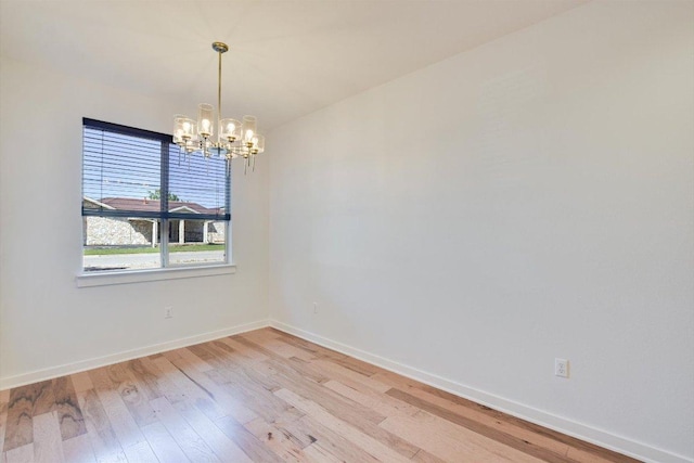 1305 Casey St Unit A, Austin, TX 78745 - empty room with a chandelier and light wood-style flooring