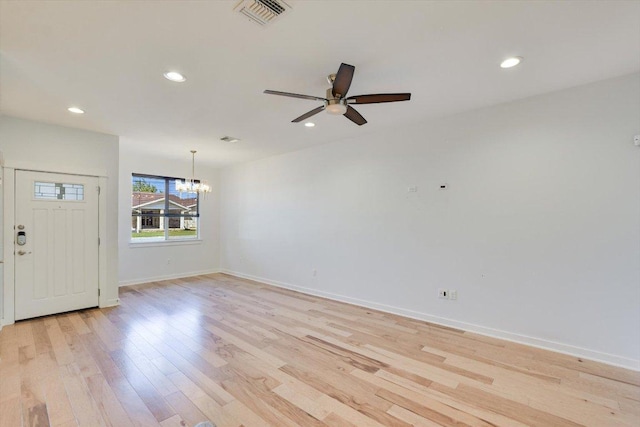 unfurnished room with a chandelier, ceiling fan, light wood-style floors, recessed lighting, and baseboards