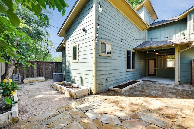 back of house with a patio area, a fenced backyard, and central AC unit
