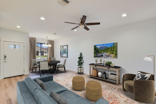 living area with ceiling fan, light wood finished floors, a chandelier, recessed lighting, and baseboards