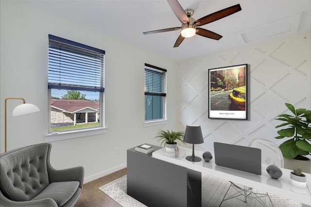 office area with ceiling fan, carpet flooring, baseboards, and attic access