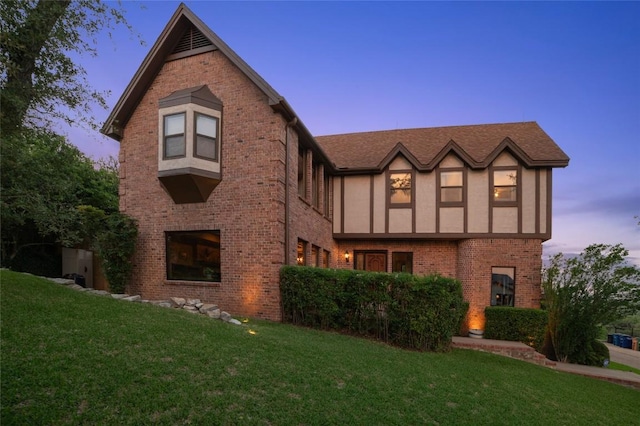 2006 Wychwood Dr, Austin, TX 78746 - view of front of house with brick siding, a lawn, and stucco siding
