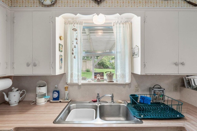 3108 W Terrace Dr, Austin, TX 78757 - kitchen with a sink, light countertops, and white cabinets