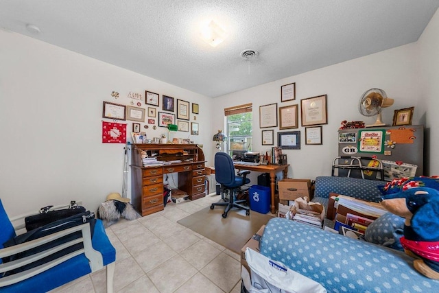 3108 W Terrace Dr, Austin, TX 78757 - bedroom with a desk, light tile patterned flooring, and a textured ceiling