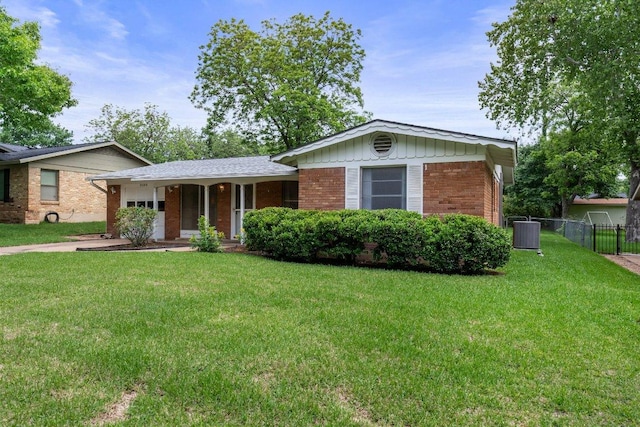 3108 W Terrace Dr, Austin, TX 78757 - view of front of house with a garage, covered porch, board and batten siding, brick siding, and central AC unit