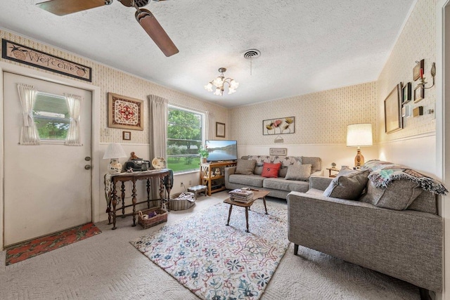 3108 W Terrace Dr, Austin, TX 78757 - living area with wallpapered walls, carpet flooring, a textured ceiling, ceiling fan, and a chandelier